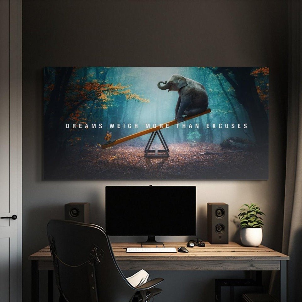 Motivational IKONICK canvas wall art of elephant on seesaw with quote 'Dreams weigh more than excuses', displayed above a modern office desk.