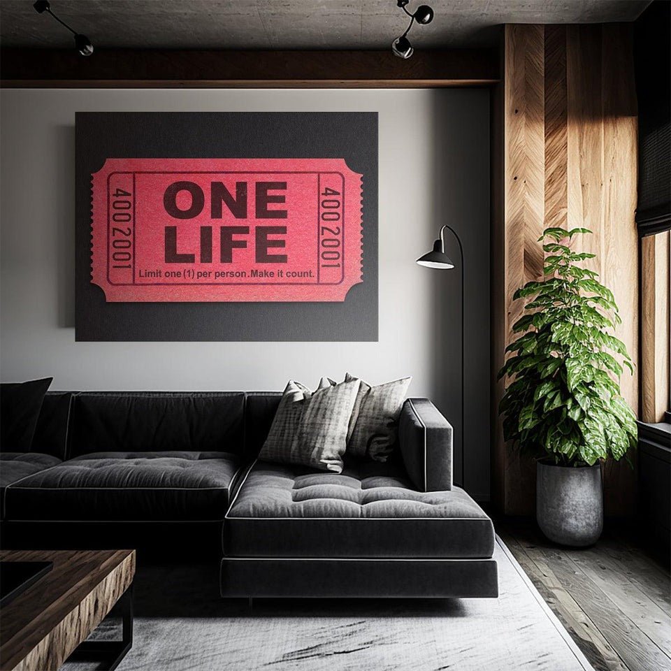Motivational canvas wall art with 'One Life' quote above a modern black sofa in a stylish living room
