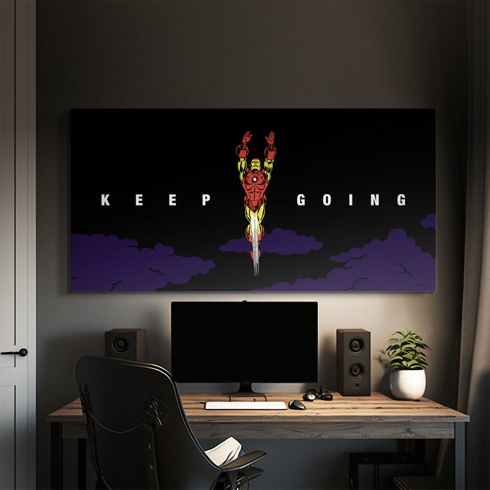 Iron Man motivational canvas wall art above desk with 'Keep Going' quote, modern workspace decor