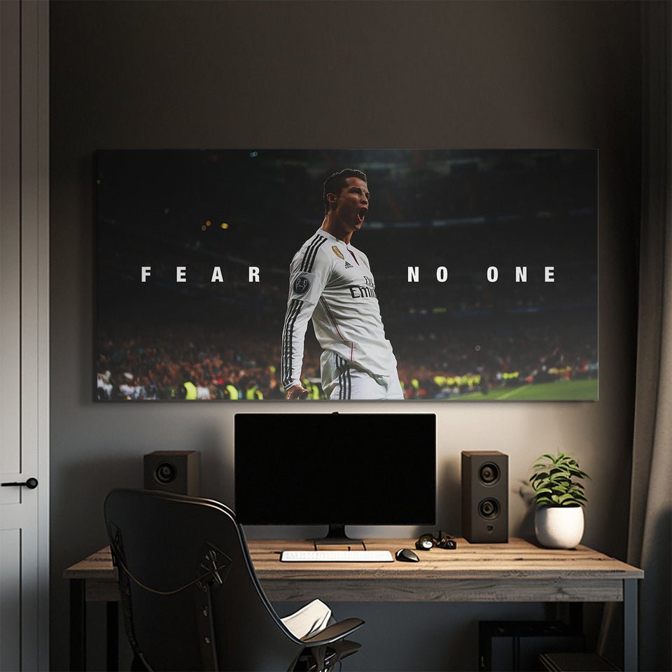 Motivational sports canvas wall art with soccer player and 'Fear No One' quote above desk setup
