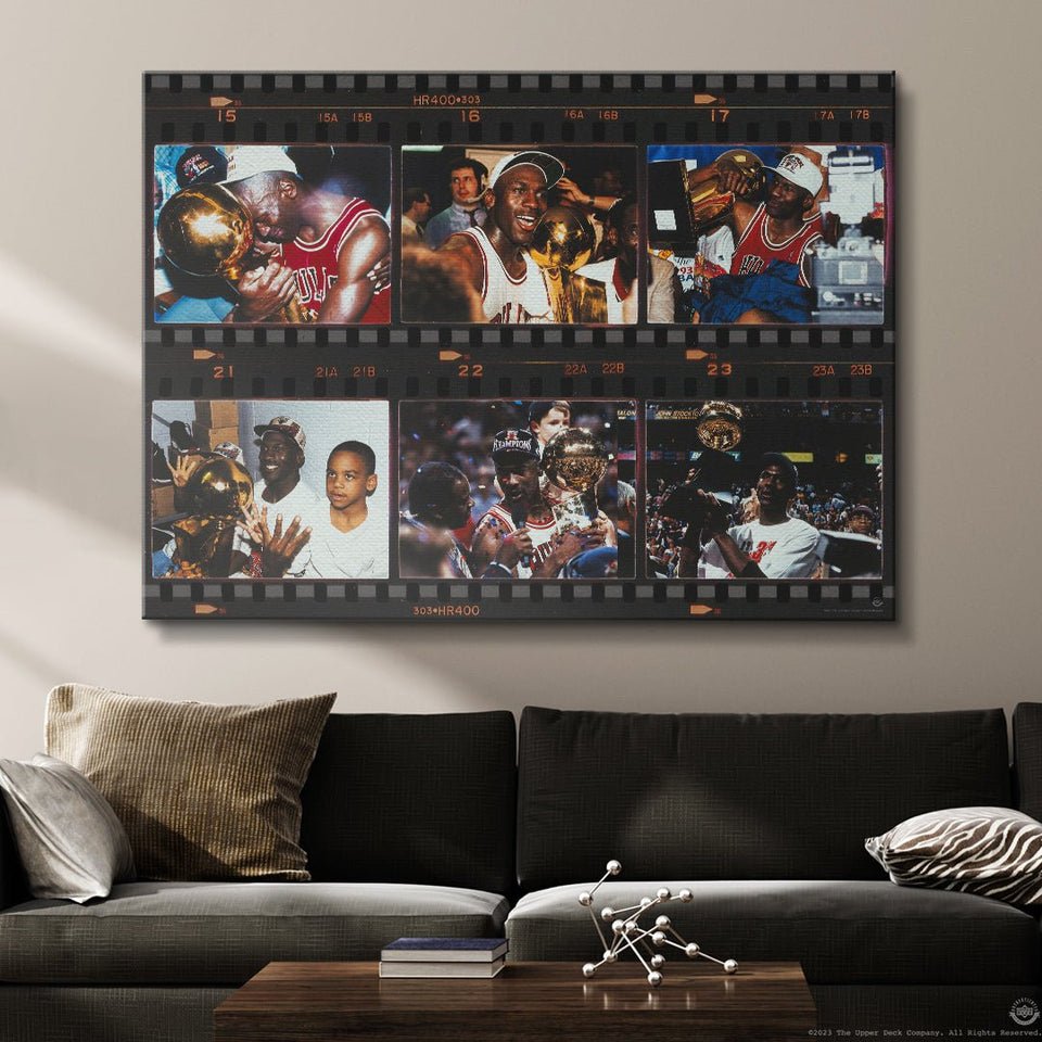 Motivational canvas wall art with iconic basketball championship moments displayed above a modern sofa.