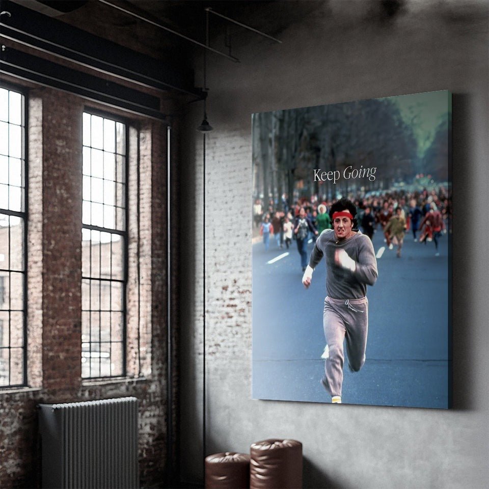 Motivational canvas wall art in a loft, featuring an athlete running with 'Keep Going' text.